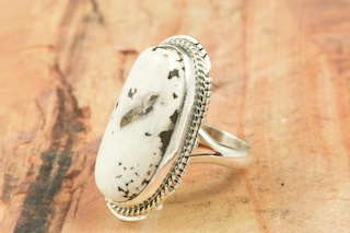 White Buffalo Turquoise set in Sterling Silver Ring. This Beautiful Stone is formed from the minerals Calcite and Iron. It is mined near Tonopah Nevada. Created by Navajo Artist Larson Lee. Signed by the artist.